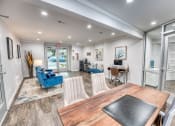 Thumbnail 21 of 36 - a dining room and living room at Juniper Springs Apartments, Austin, TX with a table and chairs