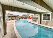 Thumbnail 26 of 36 - the pool is open to the outside of a house with a large window at Juniper Springs Apartments, Austin, TX