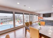 Thumbnail 30 of 36 - a dining room with a large window overlooking a swimming pool