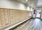 Thumbnail 35 of 37 - Mail room with numbered mailboxes and tile flooring at Le Montreaux Apartments, Austin