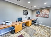 Thumbnail 25 of 37 - Business center with computer workstations and american flag at Le Montreaux Apartments, Austin, TX