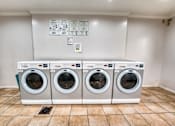 Thumbnail 37 of 37 - Laundry facility with front loading washers at Le Montreaux Apartments, Austin, TX 78759