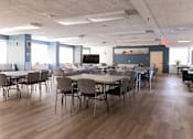 Thumbnail 10 of 34 - A conference room with a long table and chairs.