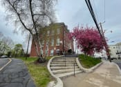 Thumbnail 1 of 2 - Historical school house building with colorful landscaping