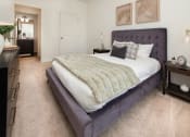 Thumbnail 10 of 44 - a bedroom with a bed and a dresser at Ardmore at the Trail, Indian Trail, NC, 28079