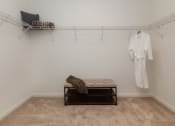 Thumbnail 9 of 44 - a white room with a white robe hanging on the wall and a white bench in the middle at Ardmore at the Trail, Indian Trail, NC