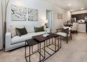 Thumbnail 5 of 44 - a living room with a white couch and a wooden coffee table at Ardmore at the Trail, Indian Trail, 28079