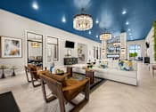 Thumbnail 17 of 35 - Spacious clubhouse lounge with blue ceiling and chandeliers at Ardmore at Prosperity Apartments, Knoxville, Tennessee