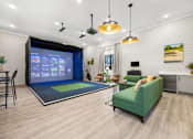 Thumbnail 21 of 35 - Indoor golf simulator lounge with seating area at Ardmore at Prosperity Apartments, Knoxville, TN 37932