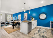 Thumbnail 8 of 35 - Open concept kitchen and dining area with blue accent wall at Ardmore at Prosperity Apartments, Knoxville