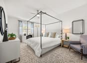 Thumbnail 12 of 35 - Spacious bedroom with canopy bed and sitting area at Ardmore at Prosperity Apartments, Knoxville, TN