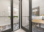 Thumbnail 28 of 35 - Glass door entrance to focus room with natural light at Ardmore at Prosperity Apartments, Tennessee, 37932