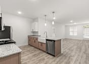 Thumbnail 28 of 30 - A modern kitchen with a black stove top oven and a dishwasher.