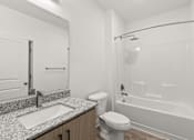 Thumbnail 12 of 30 - A white bathroom with a sink, toilet, and bathtub.