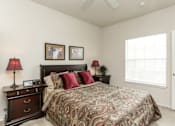 Thumbnail 7 of 12 - A bedroom with a large bed and two lamps on either side of the bed.