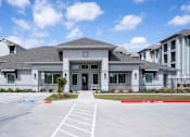 Thumbnail 8 of 9 - A modern building with a grey roof and a red stripe on the ground in front of it.