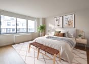 Thumbnail 7 of 26 - a bedroom with a bed and a large window