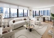 Thumbnail 13 of 26 - a living room with a view of a city and a couch and a table