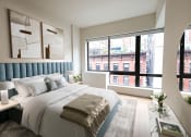 Thumbnail 20 of 26 - a bedroom with a large bed and a large window