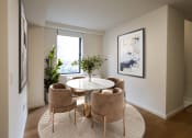 Thumbnail 14 of 26 - a dining room with a table and chairs and a window