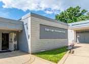 Thumbnail 39 of 39 - The Bald Eagle Reception Center is a modern building with a white exterior and a glass door.