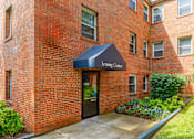 Thumbnail 1 of 39 - A brick building with a Leasing Center awning.