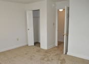 Thumbnail 34 of 39 - A room with a carpeted floor and two doors.