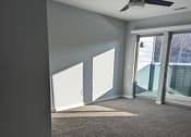 Thumbnail 8 of 115 - an empty living room with a ceiling fan and a window
