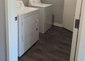 Thumbnail 6 of 115 - a laundry room with two washes and a dryer