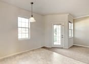 Thumbnail 76 of 137 - an empty living room with a white door and a window