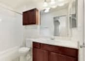 Thumbnail 5 of 137 - a blurry picture of a bathroom with a cabinet and a window