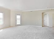 Thumbnail 33 of 137 - an empty living room with two doors and a carpeted floor