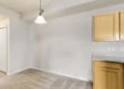 Thumbnail 4 of 137 - an empty kitchen with white walls and wooden cabinets