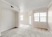 Thumbnail 62 of 137 - the living room and dining room of a new home with white walls and carpet