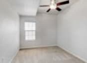 Thumbnail 11 of 137 - a white room with a ceiling fan and a window