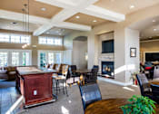 Thumbnail 106 of 137 - a living room with a bar and a fireplace