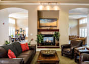 Thumbnail 109 of 137 - a living room with a fireplace and leather furniture
