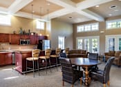 Thumbnail 107 of 137 - a clubhouse with a dining room and a bar with chairs