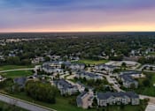 Thumbnail 125 of 137 - an aerial view of a neighborhood of houses at sunset