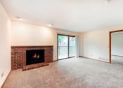 Thumbnail 22 of 31 - a living room with a fireplace and a door to a balcony