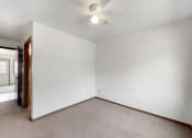 Thumbnail 51 of 54 - an empty living room with white walls and a ceiling fan