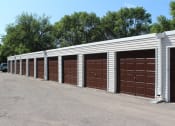 Thumbnail 3 of 13 - a row of garage doors in a parking lot