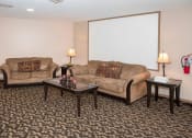 Thumbnail 26 of 30 - a living room with couches and tables