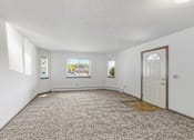 Thumbnail 32 of 38 - an empty living room with a white door and carpet