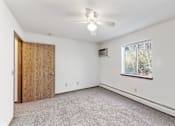 Thumbnail 37 of 38 - an empty bedroom with a ceiling fan and a window
