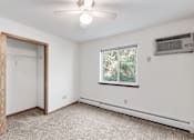 Thumbnail 35 of 38 - an empty room with white walls and a window and a ceiling fan