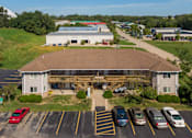 Thumbnail 3 of 38 - an aerial view of a building with cars parked in a parking lot