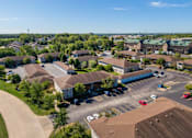 Thumbnail 5 of 38 - an aerial view of a neighborhood of houses with cars in a parking lot