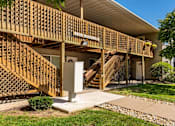 Thumbnail 10 of 38 - the front of a house with stairs and a porch