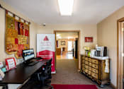 Thumbnail 18 of 38 - a office with a desk and a computer in a room